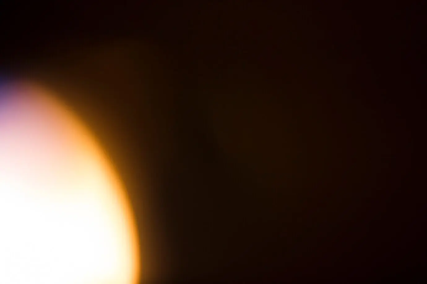 A bright light against a black background.